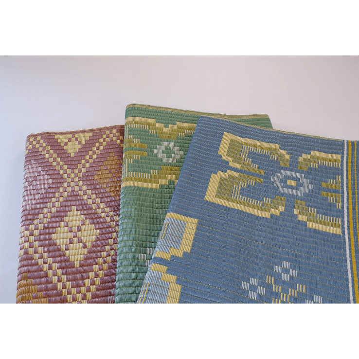 Maroon, green and blue folded Vinay's Series woven mats with cream yellow cross and abstract designs